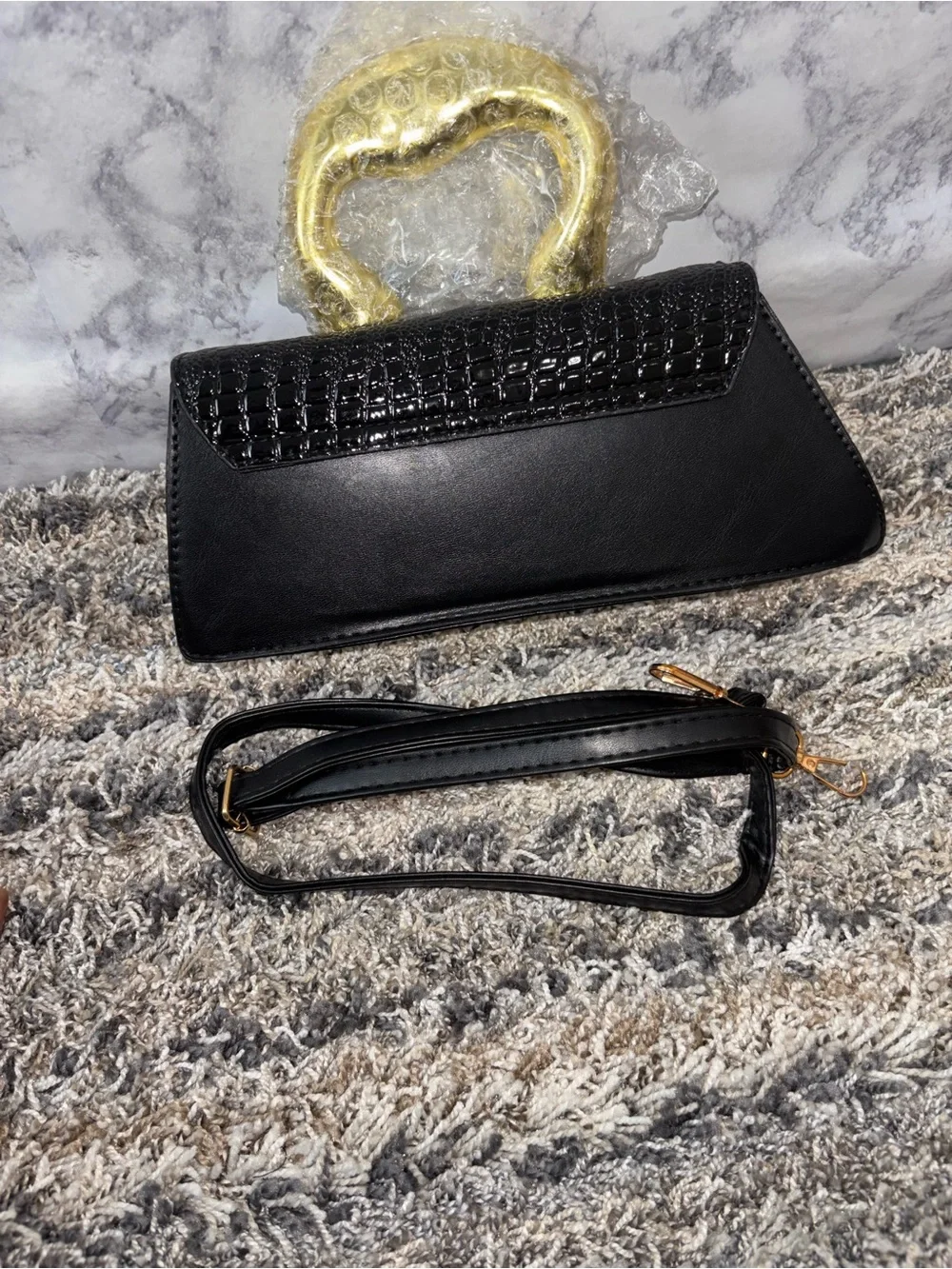 Elegant Black Textured Clutch with Gold Accent Handle